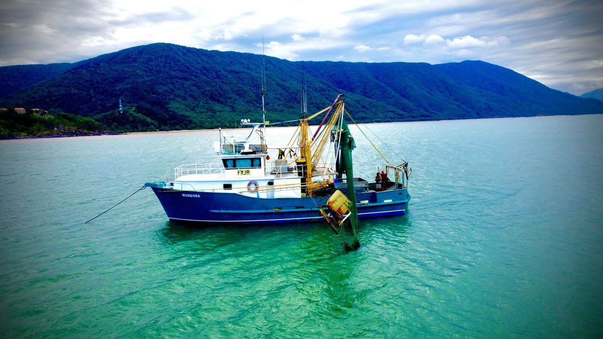 fishing vessel on Water with Mountains and Sky in Background — Locally Caught Fresh Prawns in Portsmith, QLD