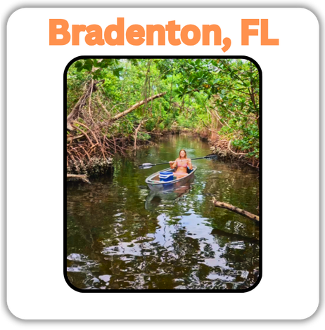 girl kayaking into a mangrove tunnel.