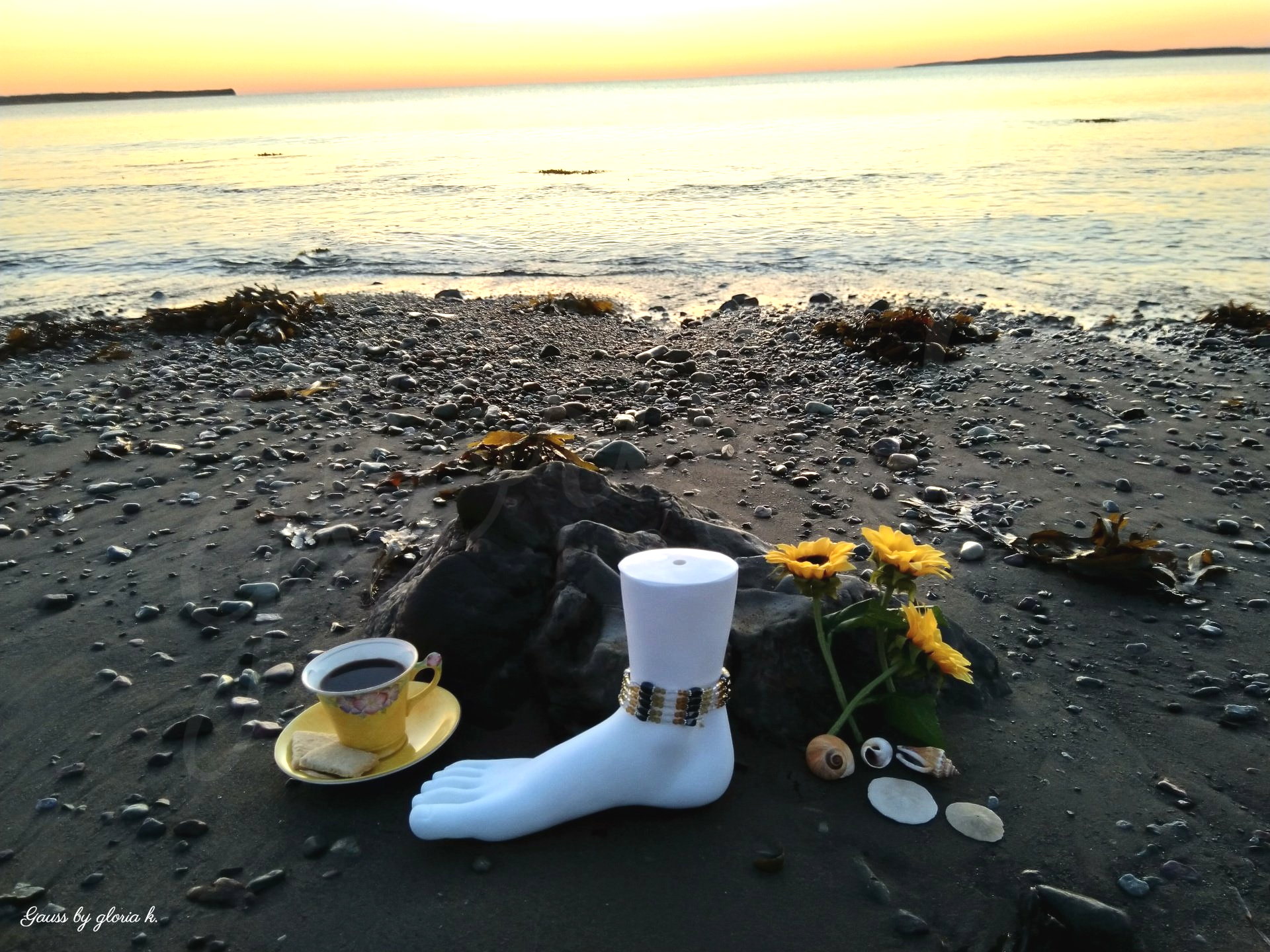 Amber Glow magnetic hematite wrap anklet on seashore at sunrise