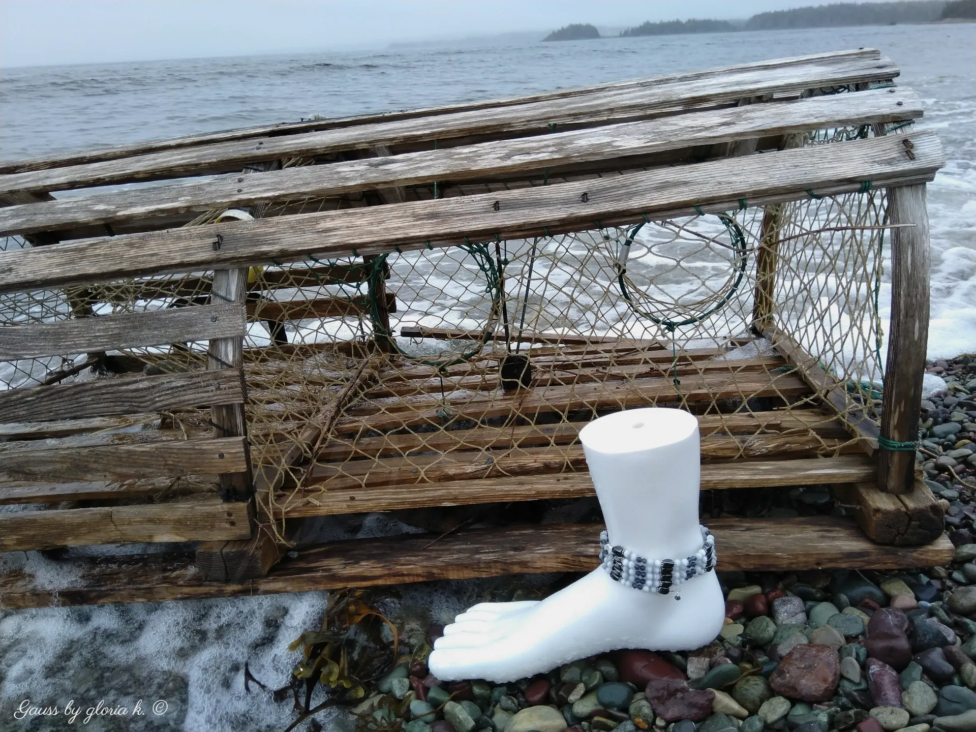 Blue Fog magnetite hematite wrap anklet beside lobster trap on beach