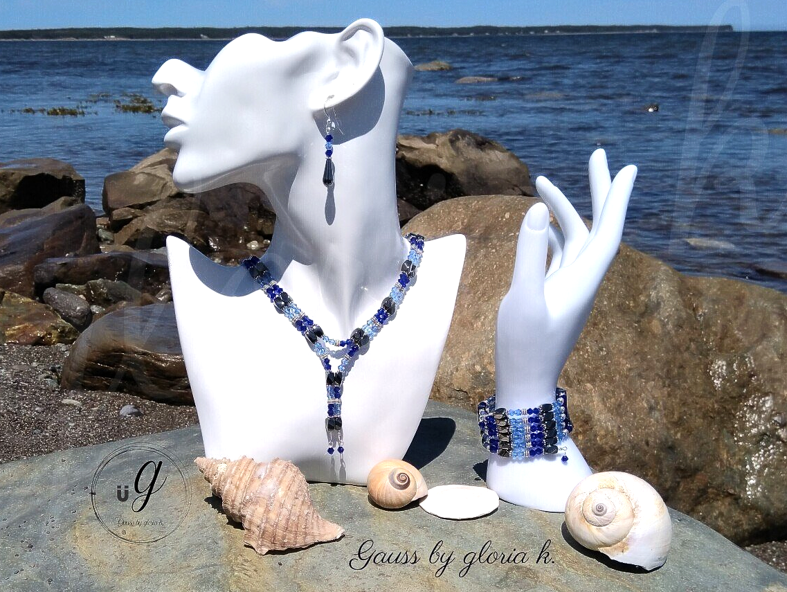 Blue Storm magnetic hematite wrap necklace and bracelet on sea boulder