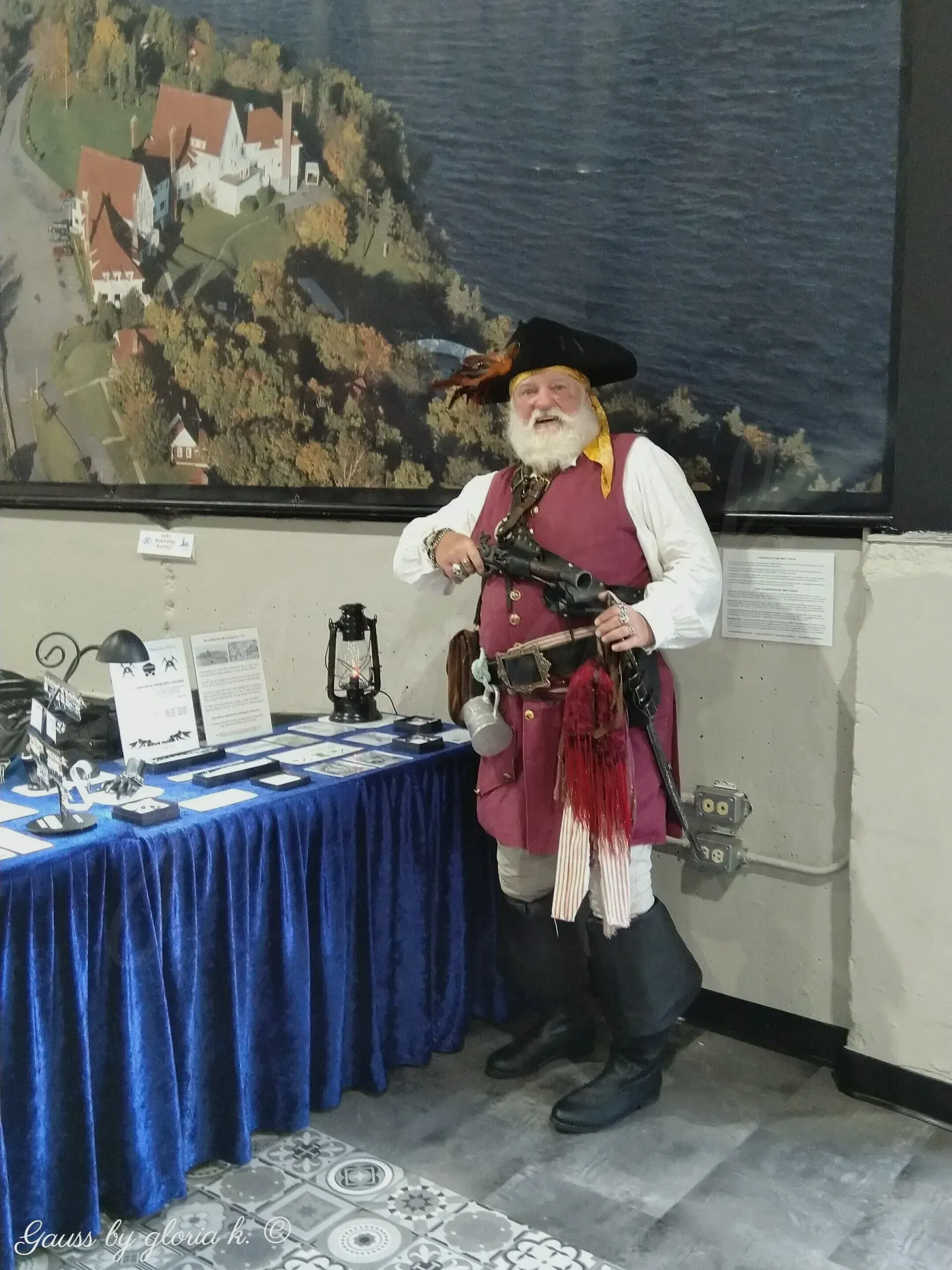 Costumed pirate beside gloria k. magnetic jewellery display.