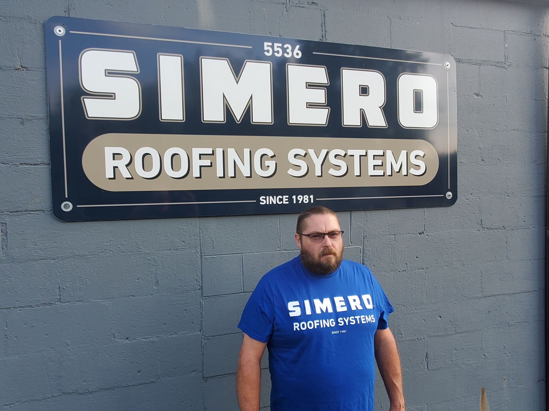 Man in blue shirt in front of a