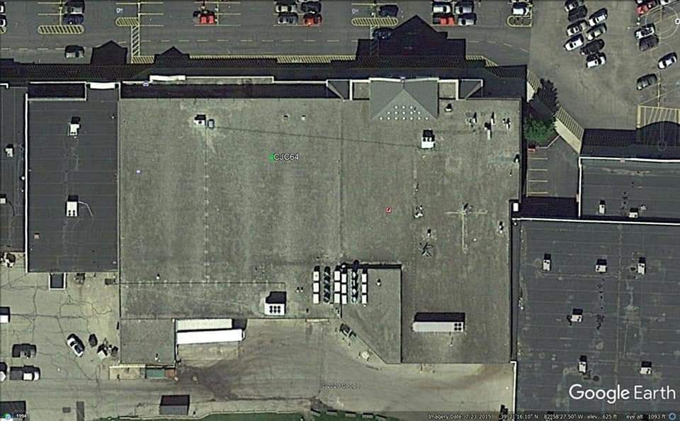 Aerial view of a large commercial building with a loading dock and surrounding parking lots.