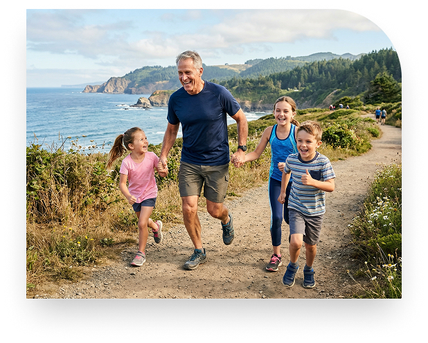 A happy grandfather running on a coastal trail with his three grandchildren.