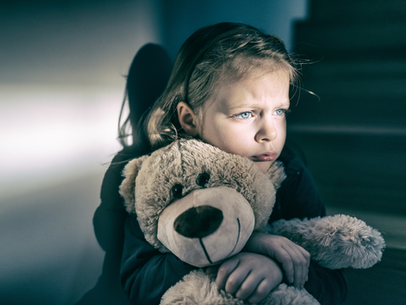 A little girl is holding a teddy bear in her arms - Hickory, NC - Giving Kids Hope Foundation 