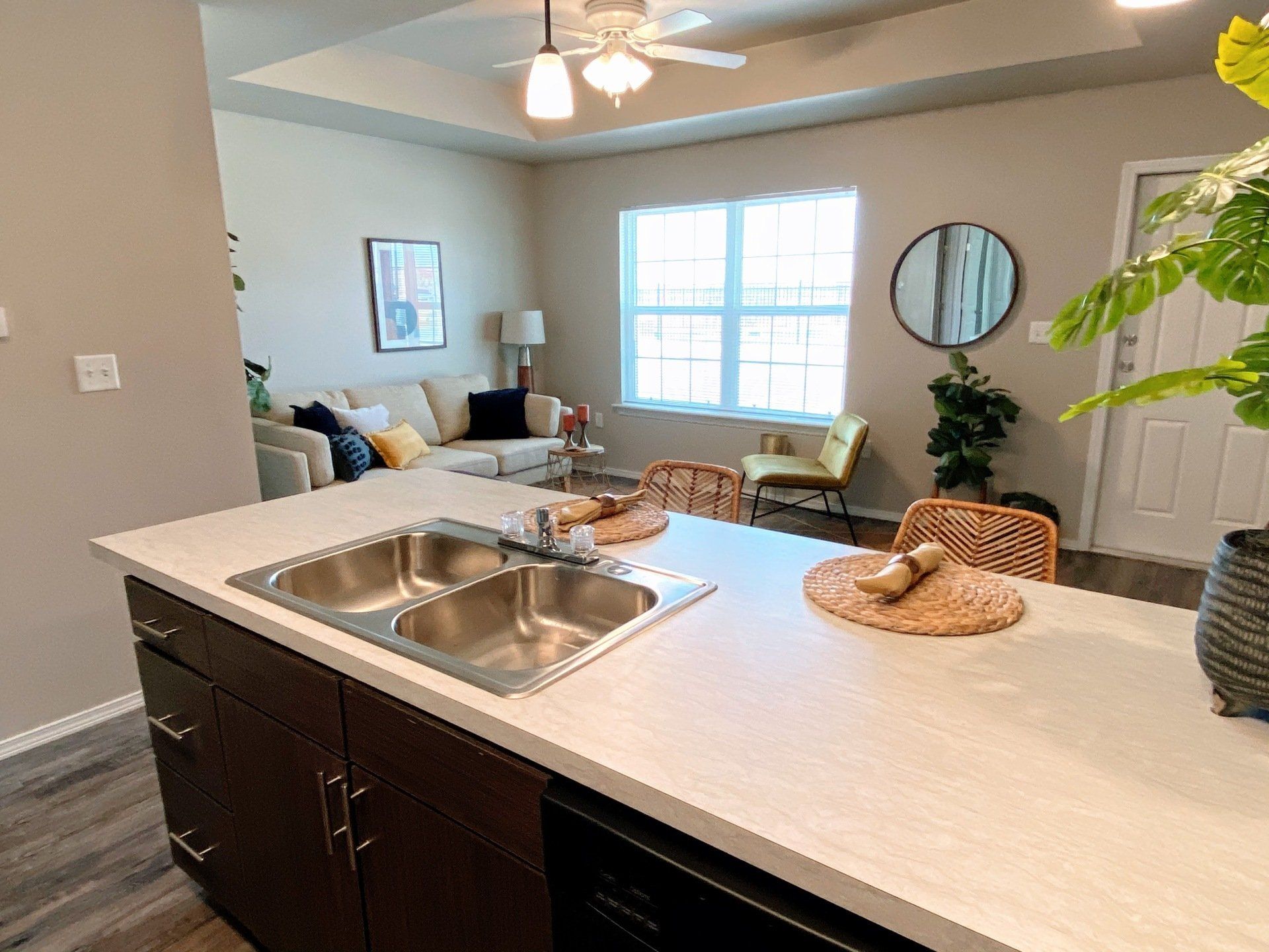 Kitchen counter with sink looking into living room