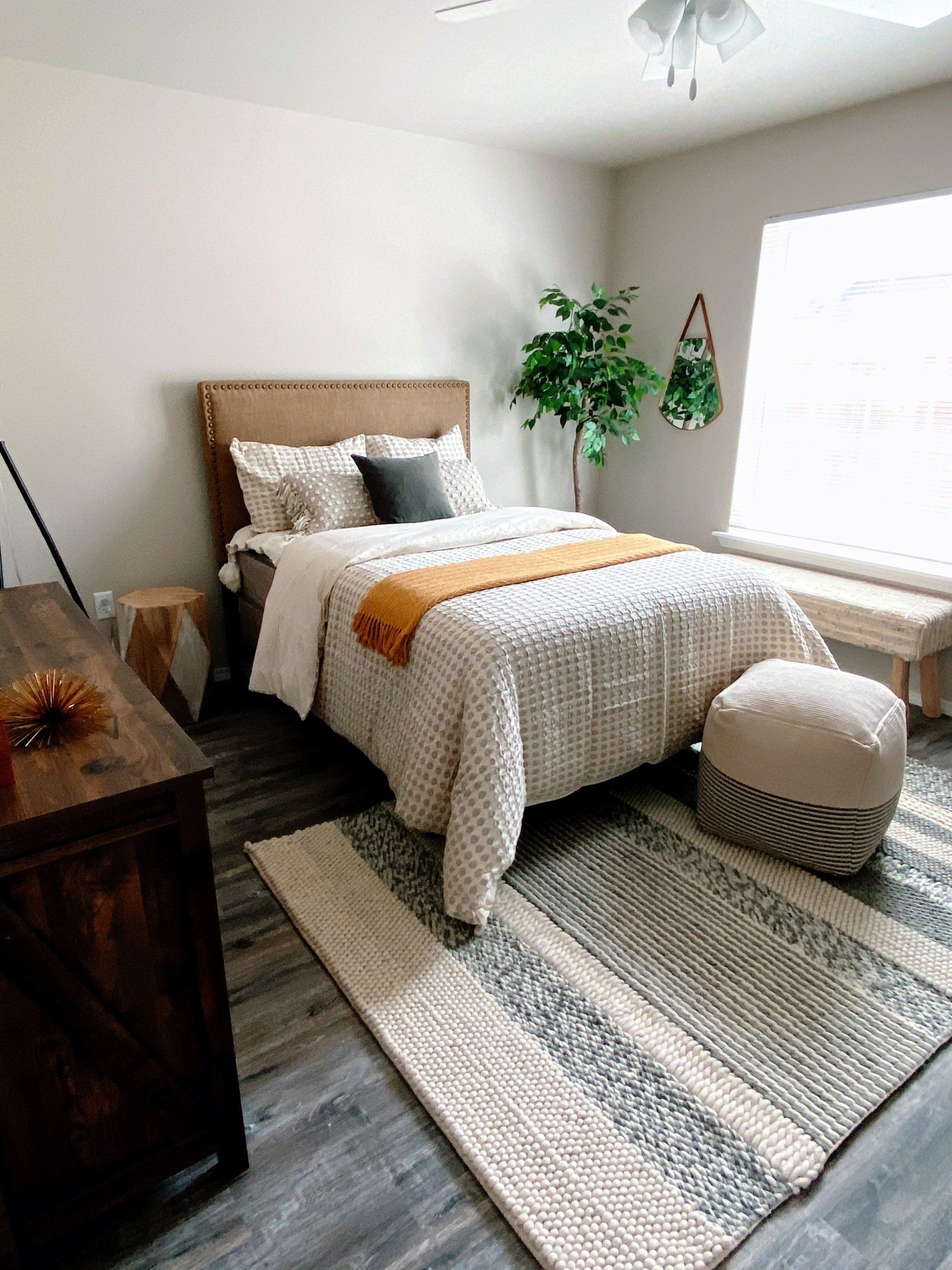 Bed in second bedroom with boho decor
