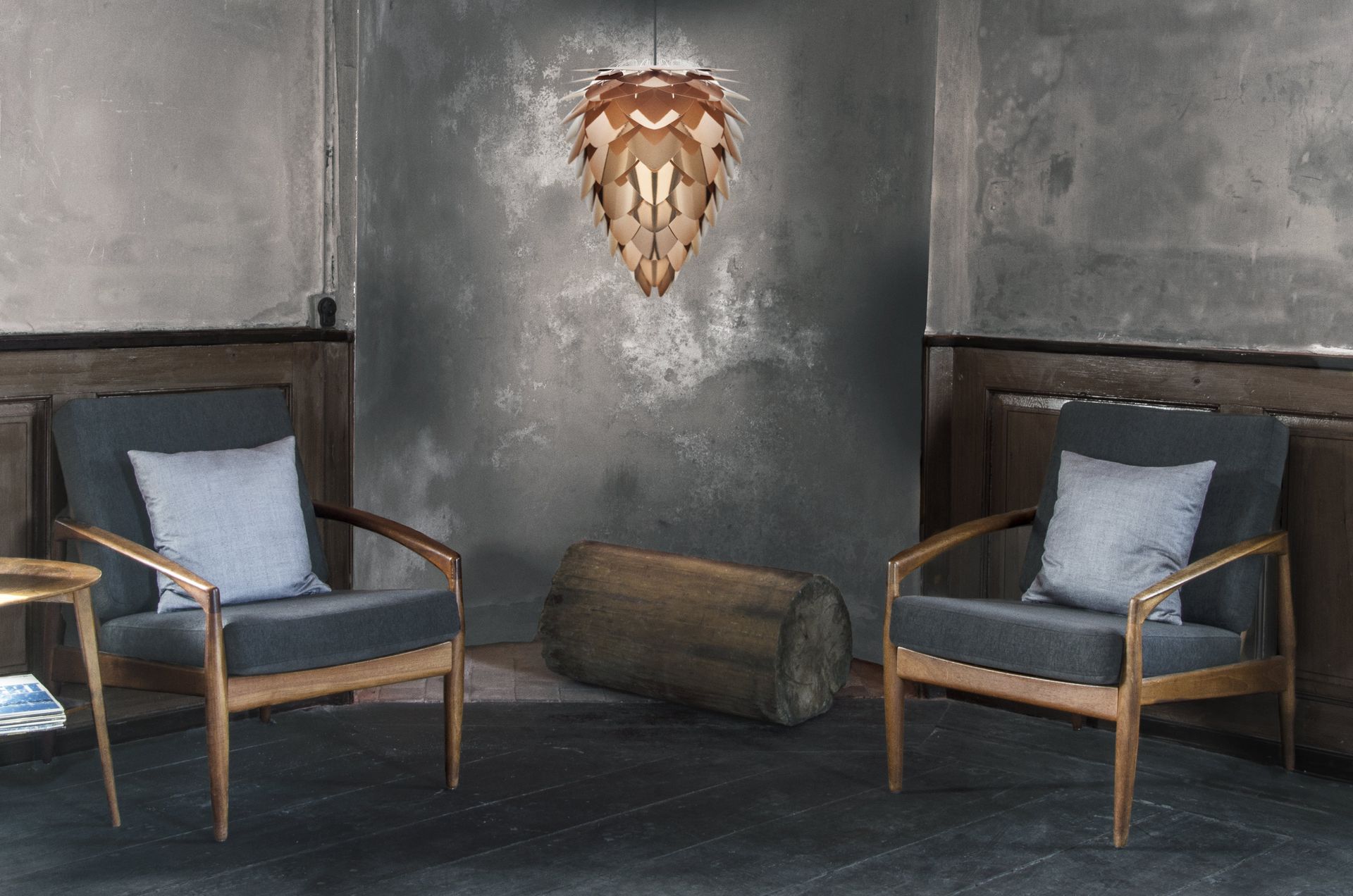 Two chairs are sitting in a room with a wall behind them.