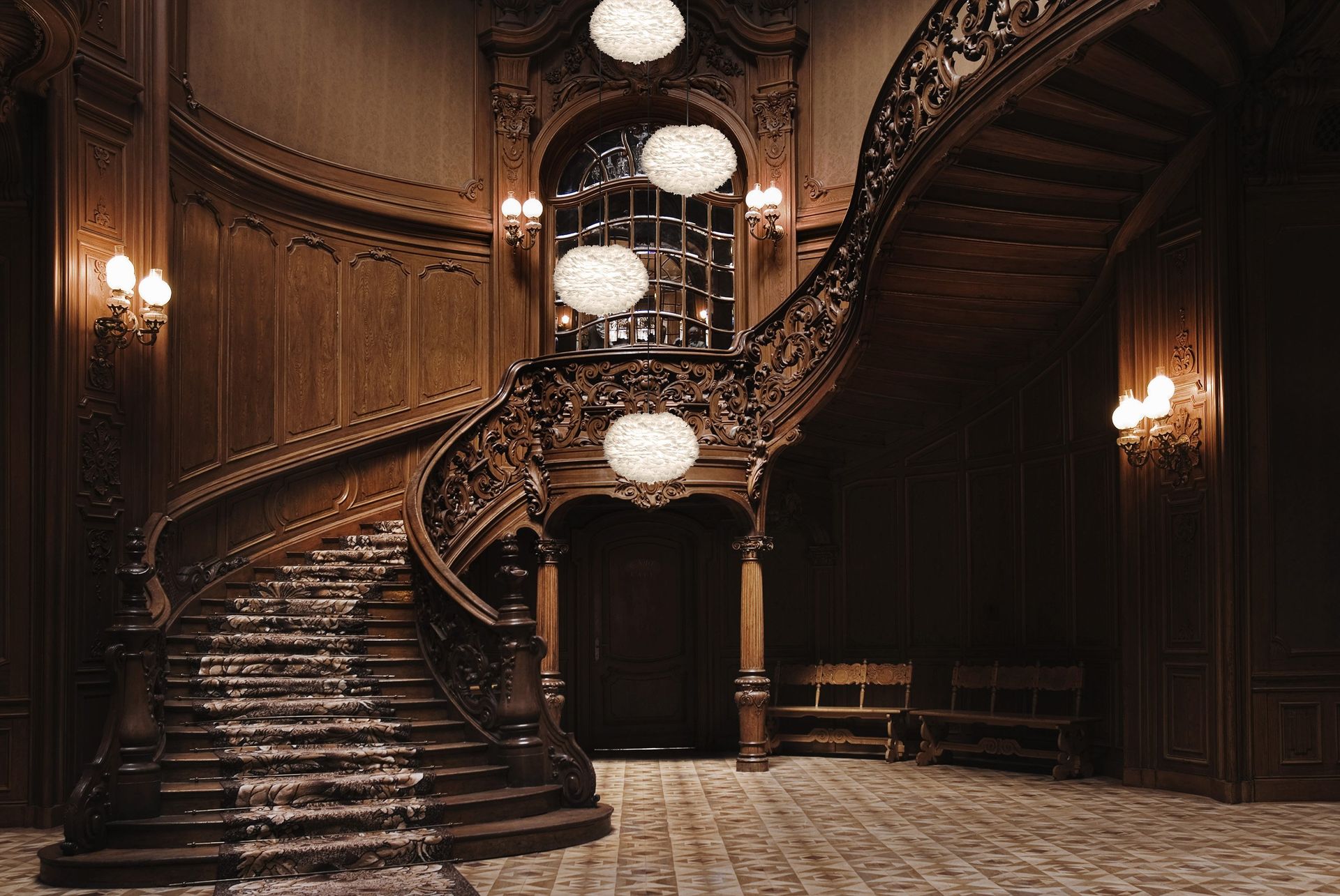 There is a large wooden staircase in the middle of the room.