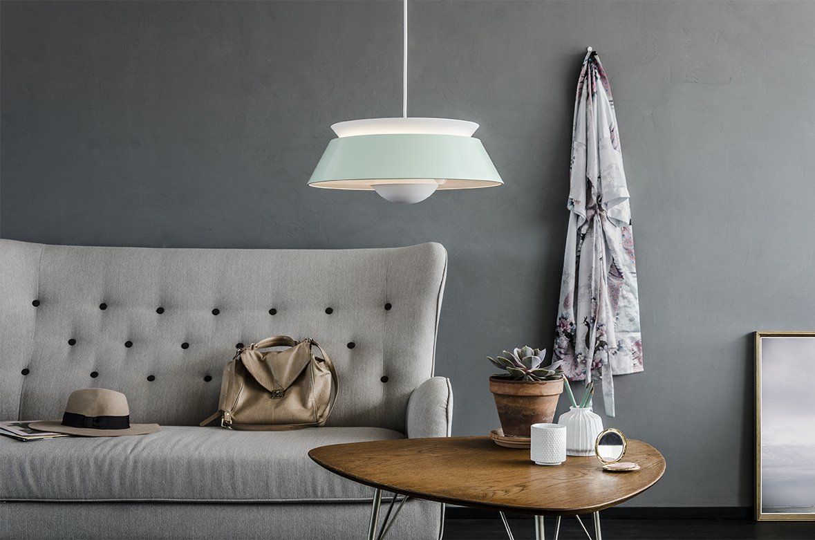 A living room with a couch a table and a lamp
