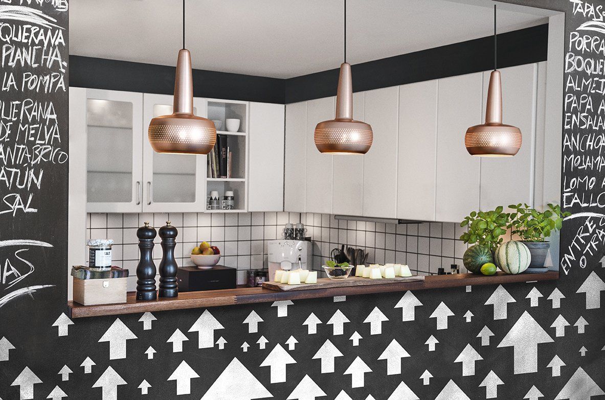A kitchen with a chalkboard with arrows on it