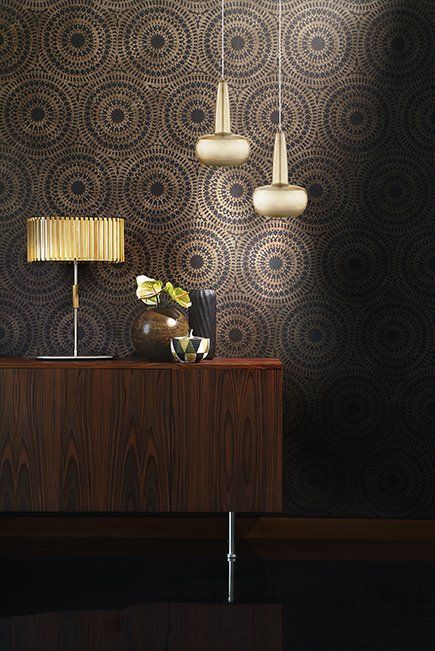 A table with a lamp and a vase on it