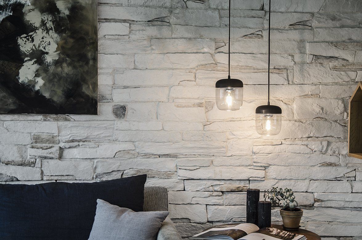 A living room with a brick wall and a couch