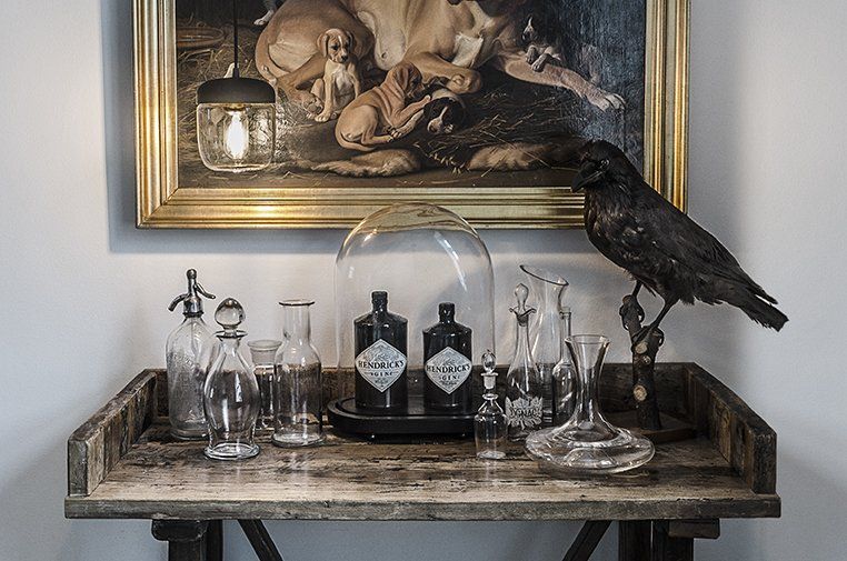 A table with bottles and a bird on it