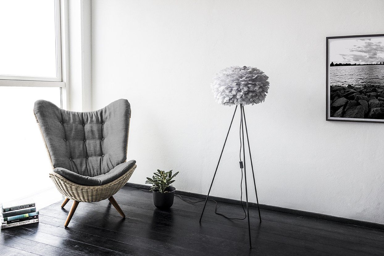 There is a chair and a lamp in the room.