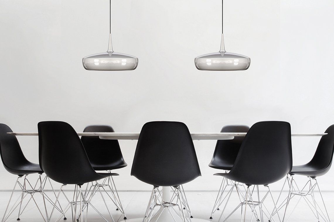 A dining room with black chairs and a white table