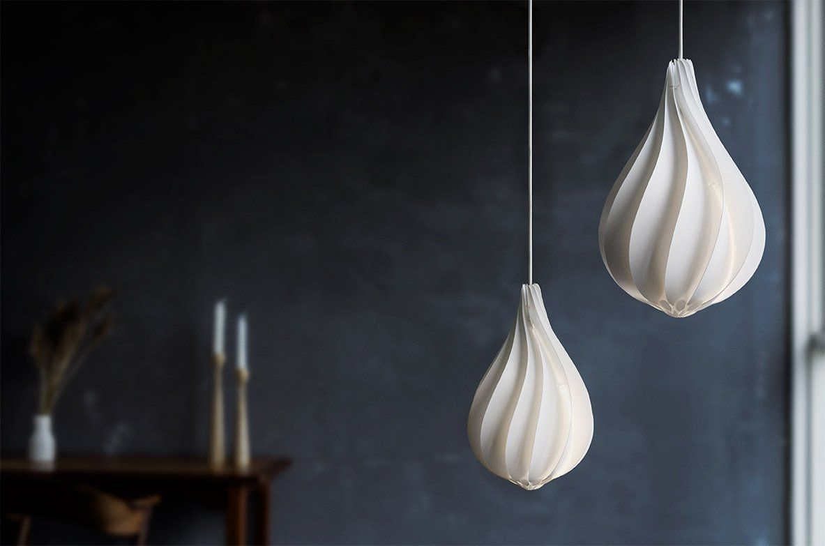 Two white pendant lights are hanging from the ceiling in a dark room.
