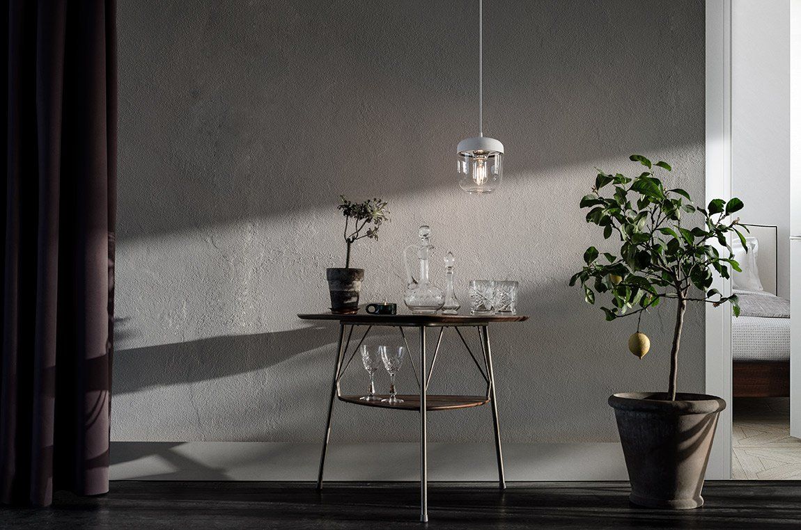 A room with a table and a potted plant.