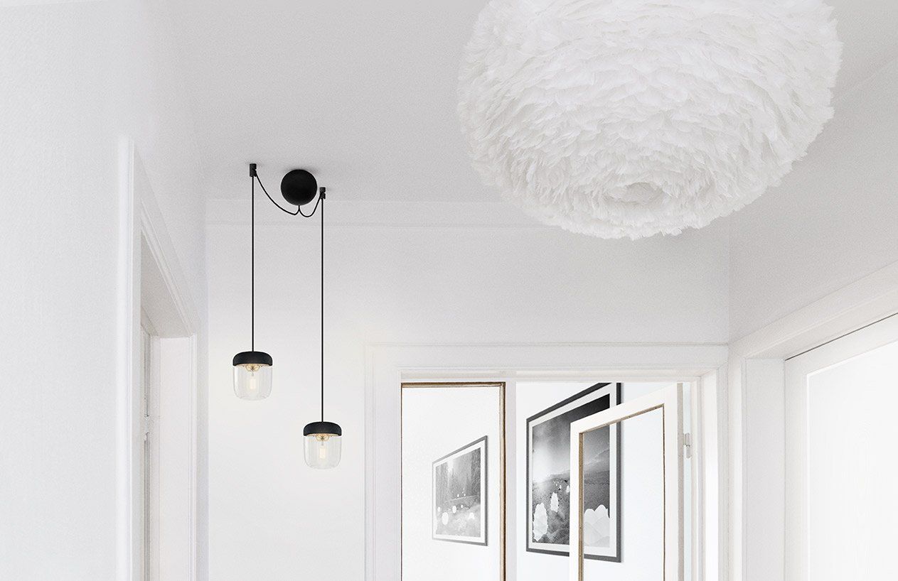 A hallway with a white feather pendant light hanging from the ceiling.