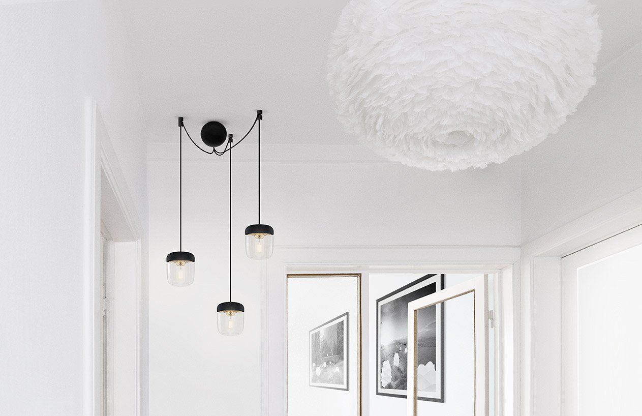 A hallway with a white feather pendant light hanging from the ceiling.
