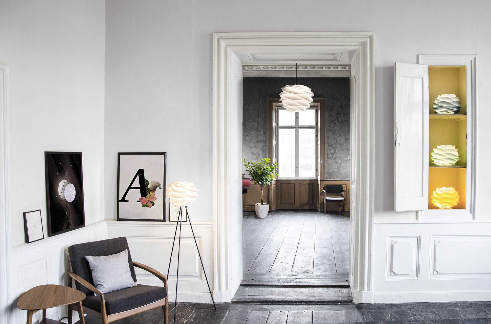 A living room with a chair , table and lamp.