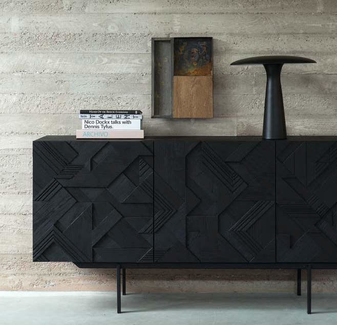 A black cabinet with a lamp on top of it