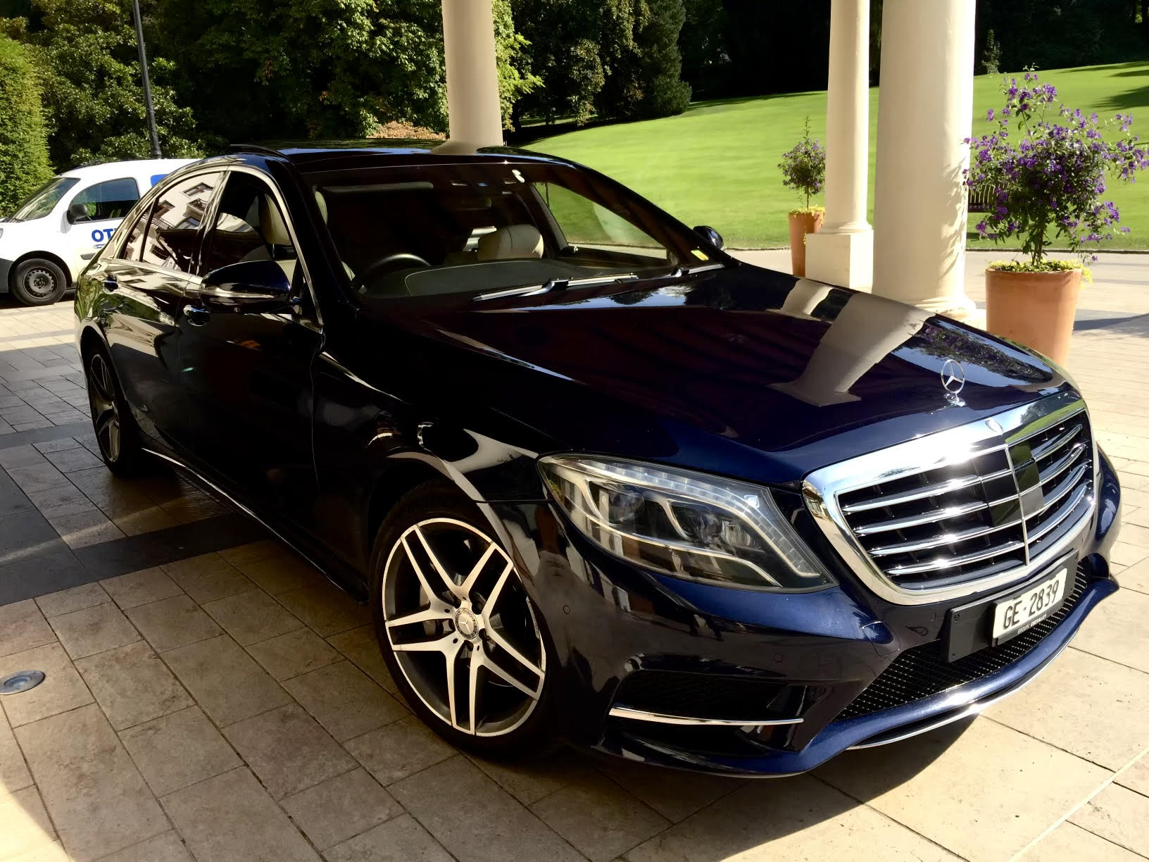 Black sedan parked under cover