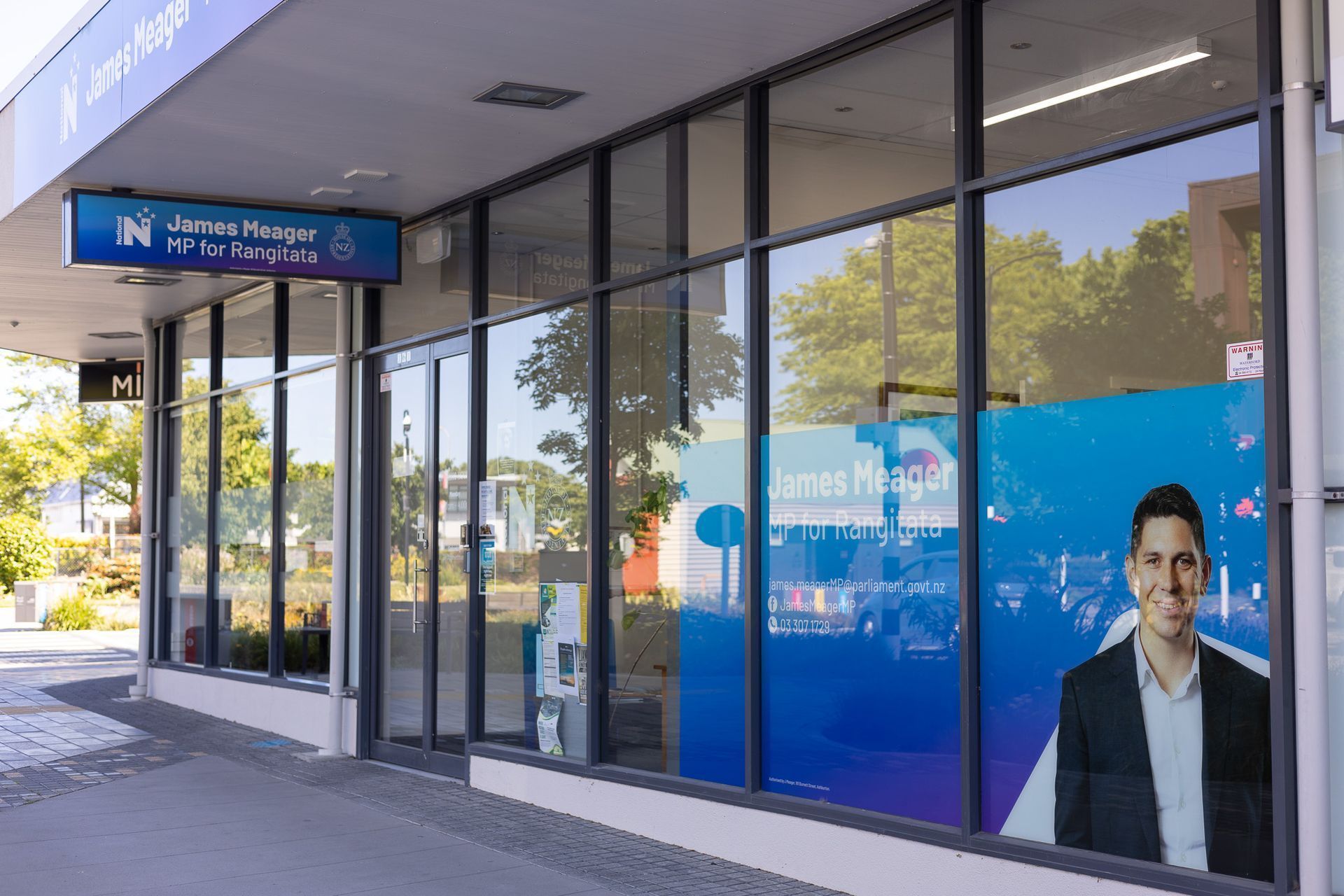 Bank storefront with large windows, sign