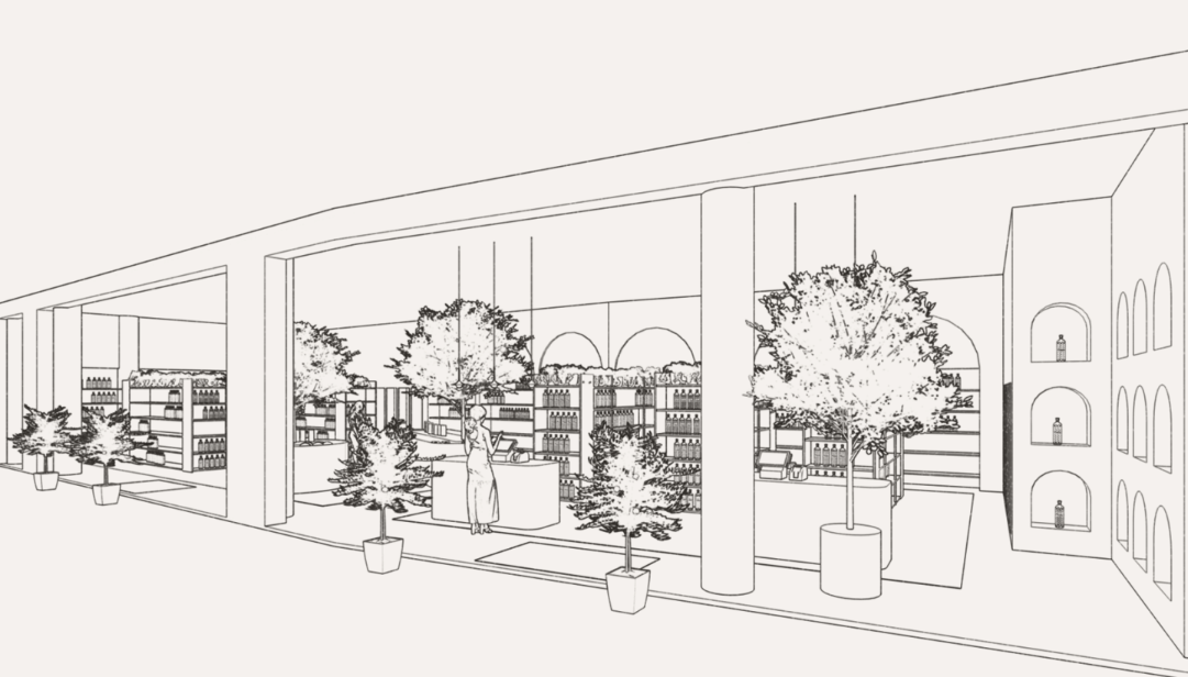 Long, covered arcade with shops, red tile floor, glass ceiling, plants, benches.