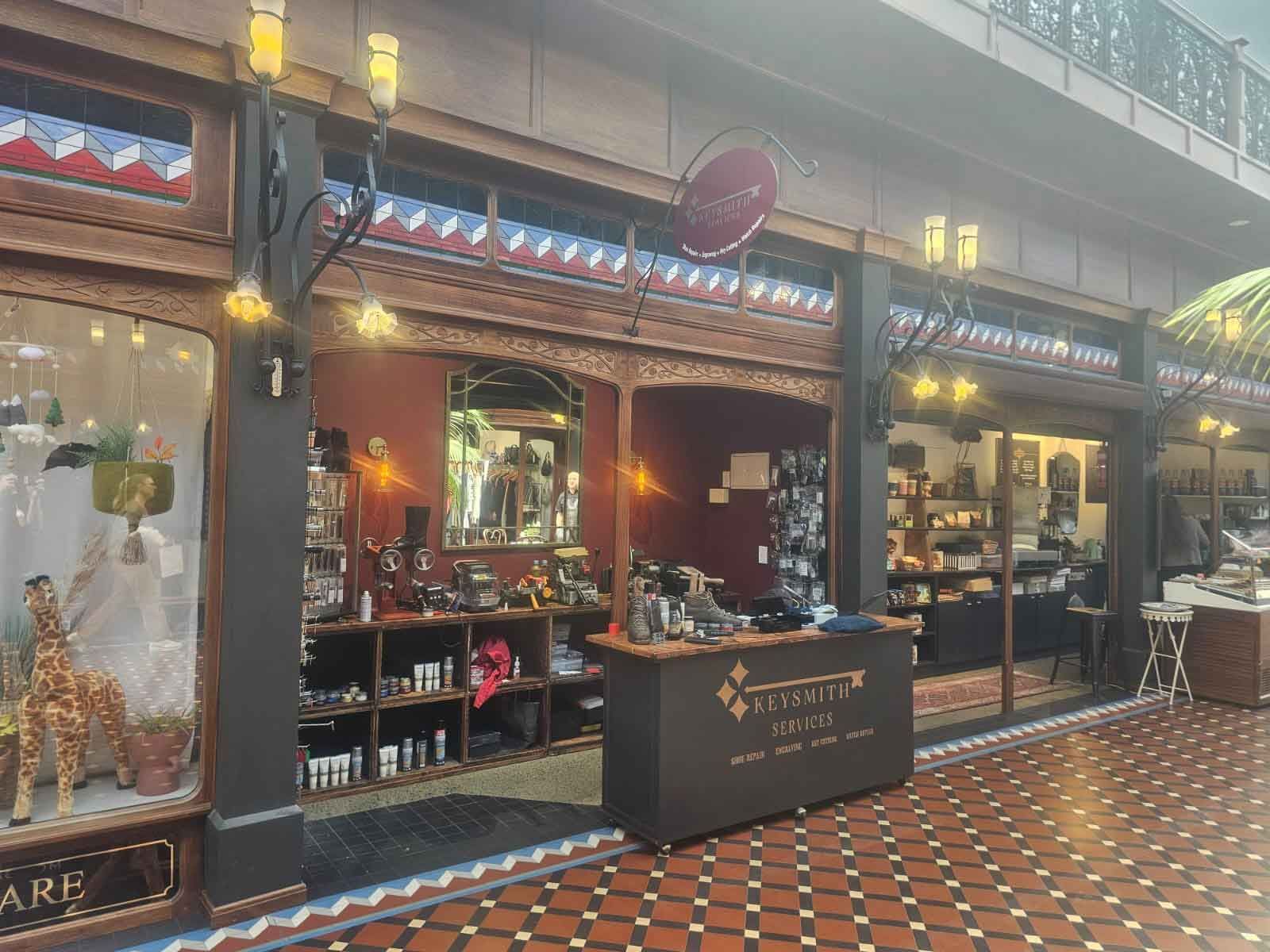 Boutique exterior: brown wooden facade, red walls, displayed goods, shop sign, tile floor.