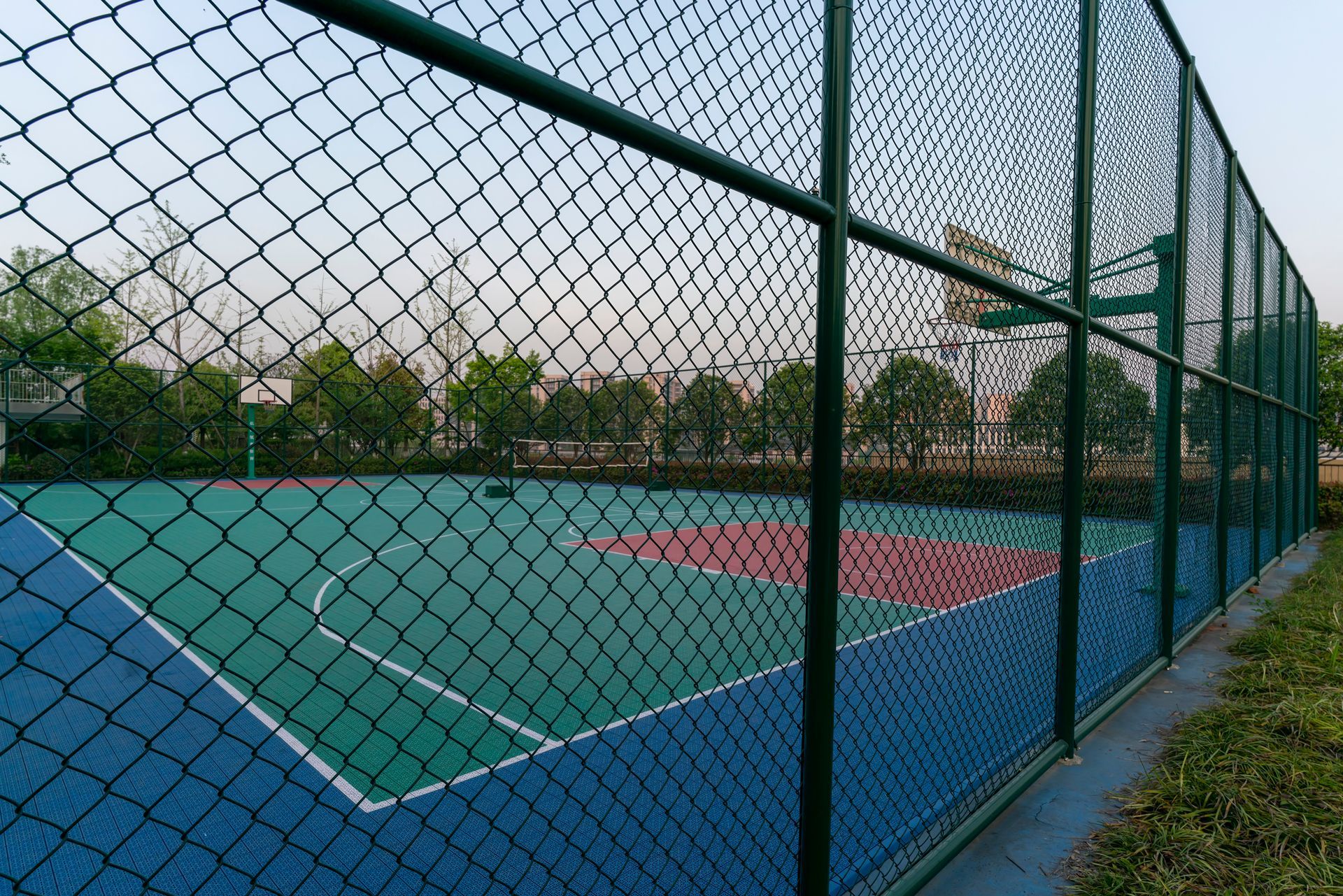 A chain link fence with a blue sky in the background