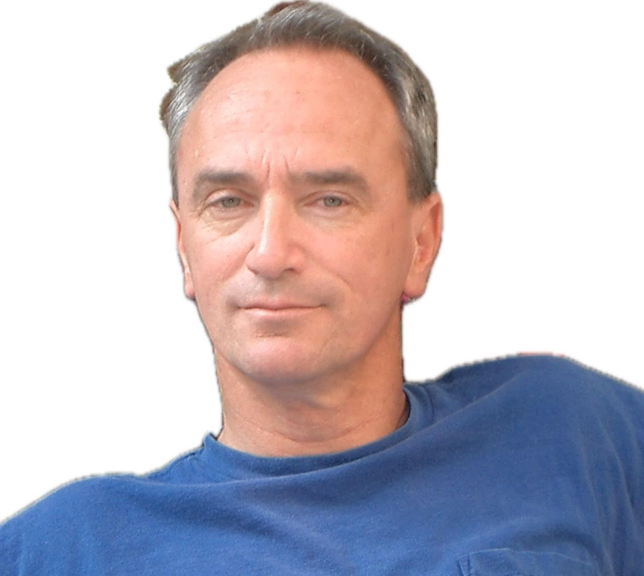 Man with graying hair in blue shirt, looking toward the camera.