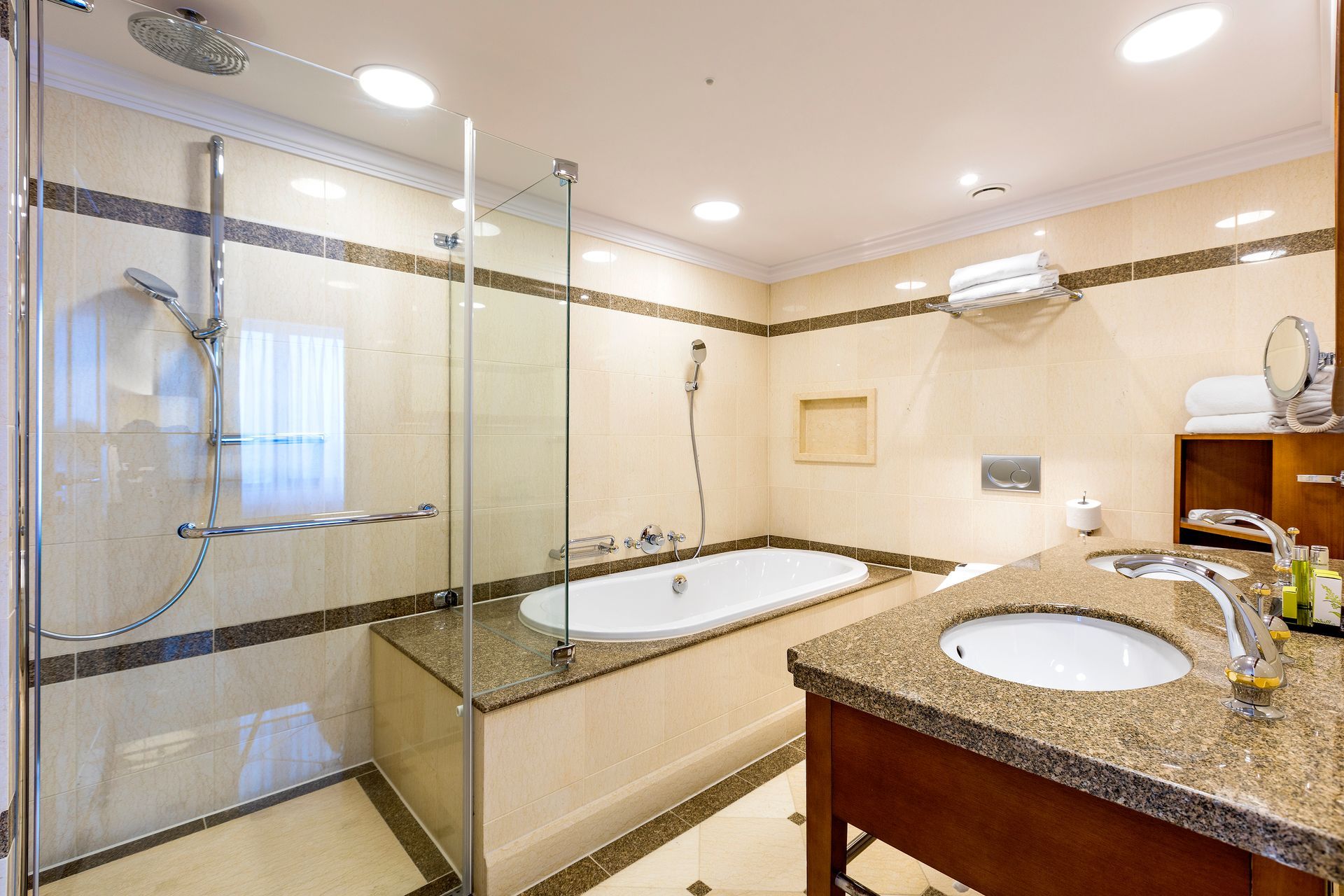 A bathroom with a bathtub , sink , and shower.
