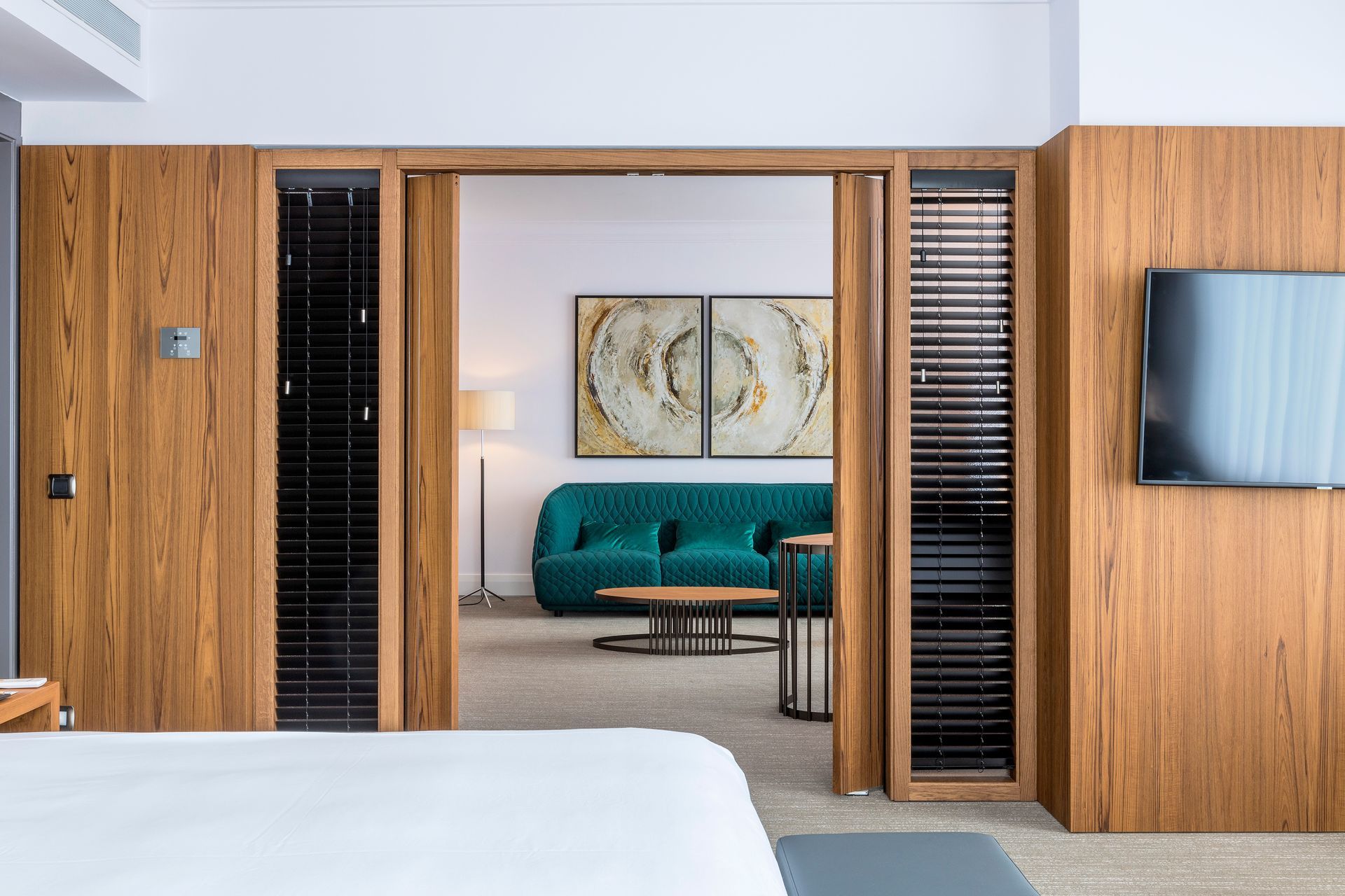 A hotel room with a bed , couch and television.