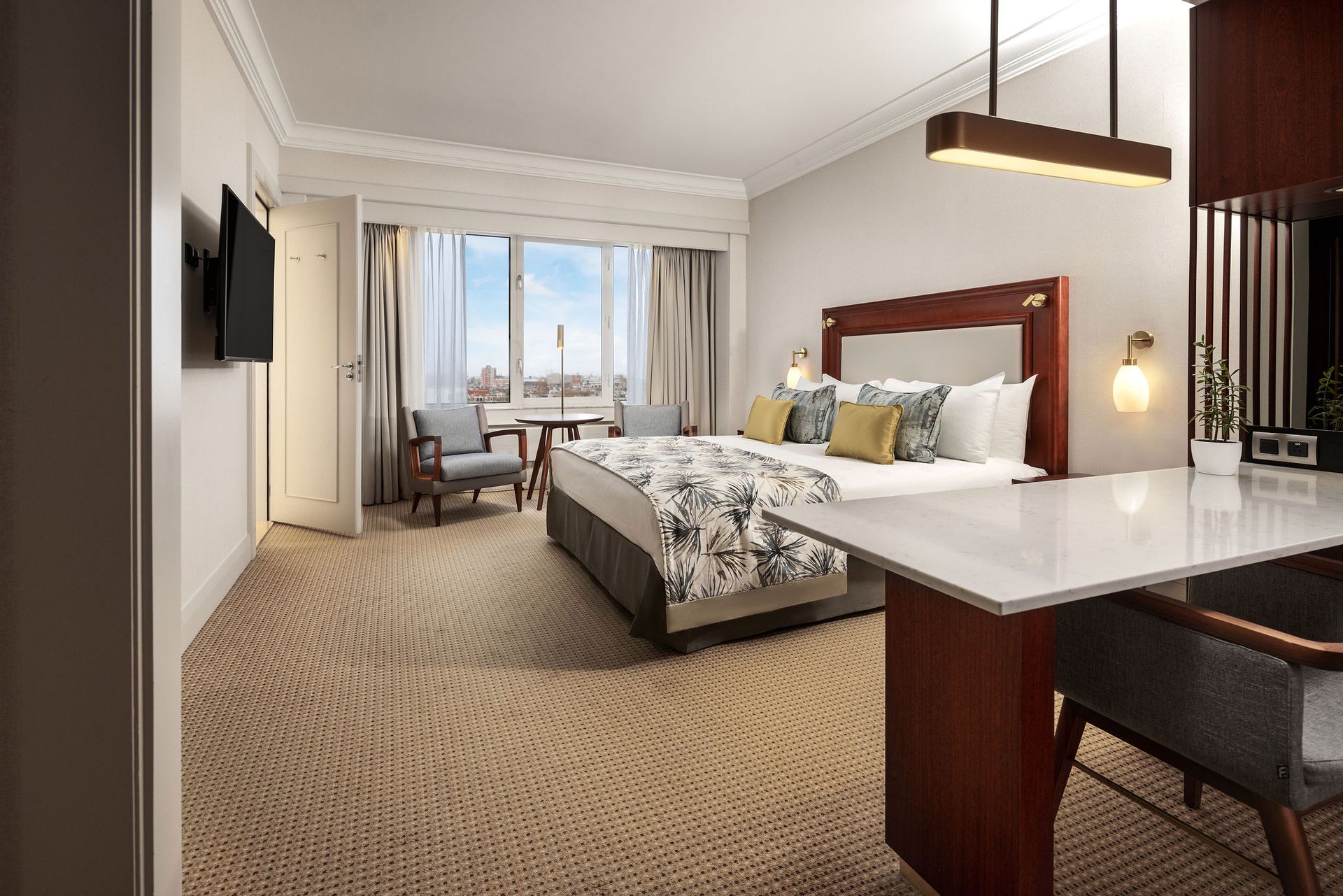 An artist 's impression of a hotel room with a king size bed and a table.