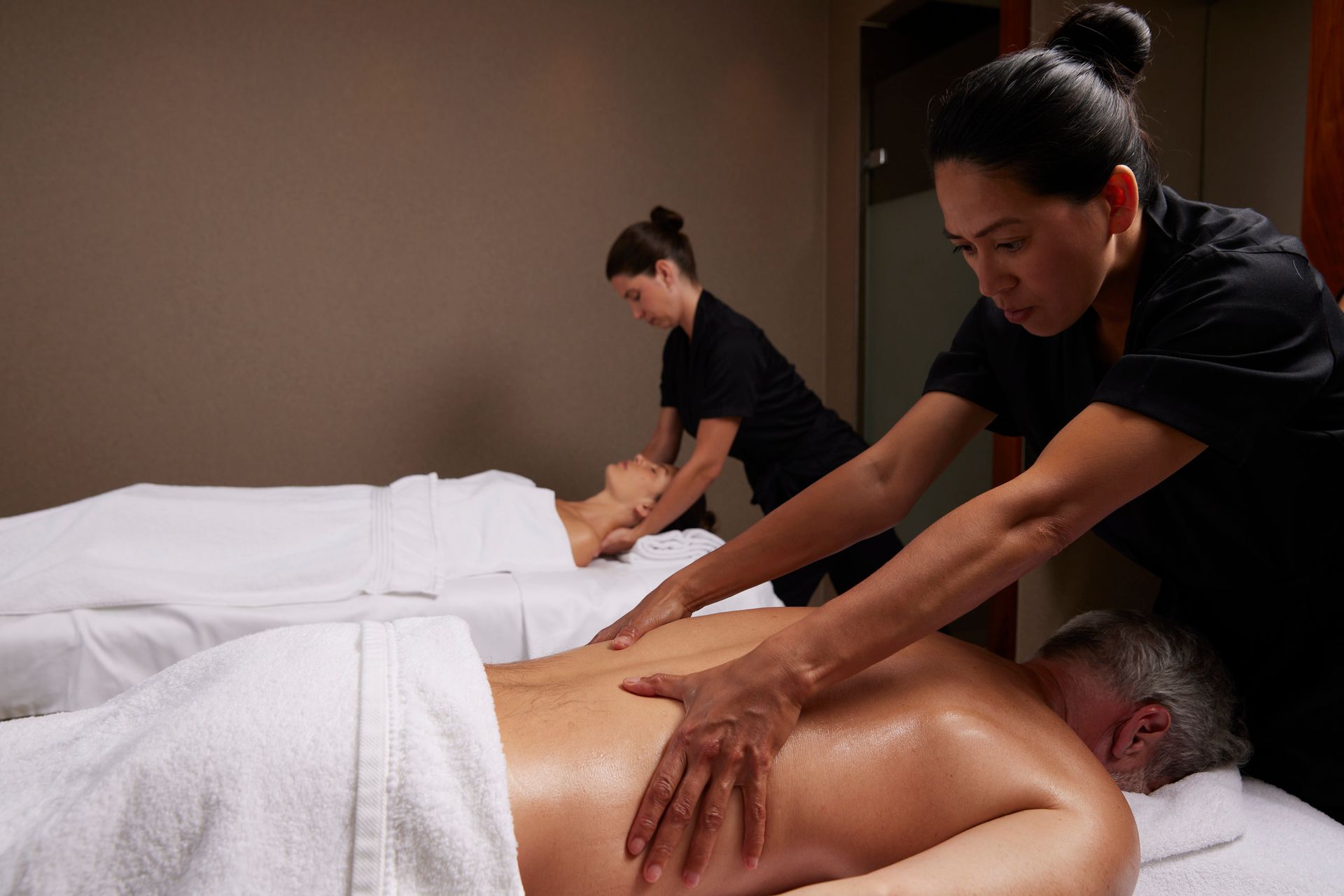 Two people are getting a massage in a spa.