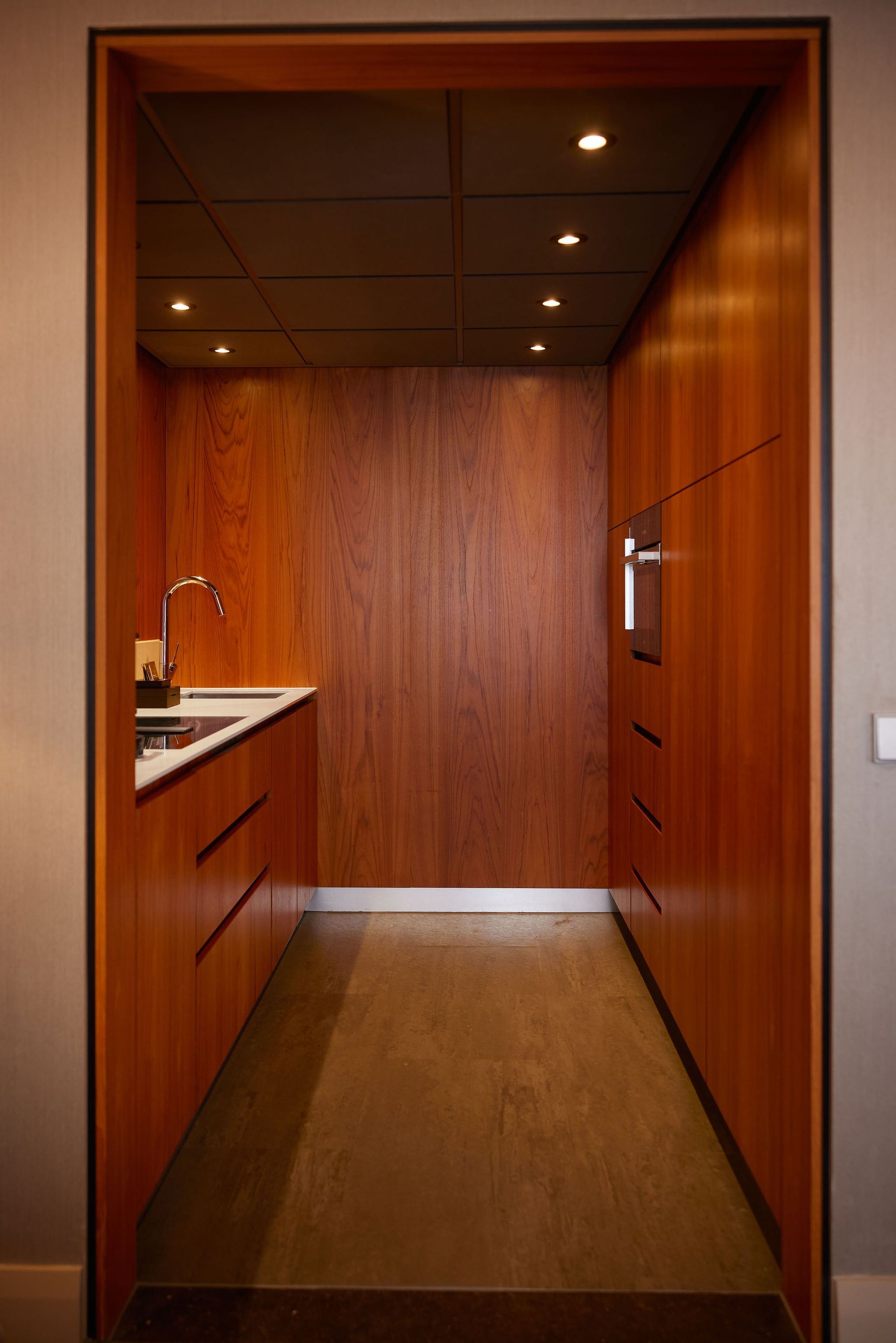 A kitchen with wooden cabinets and a sink