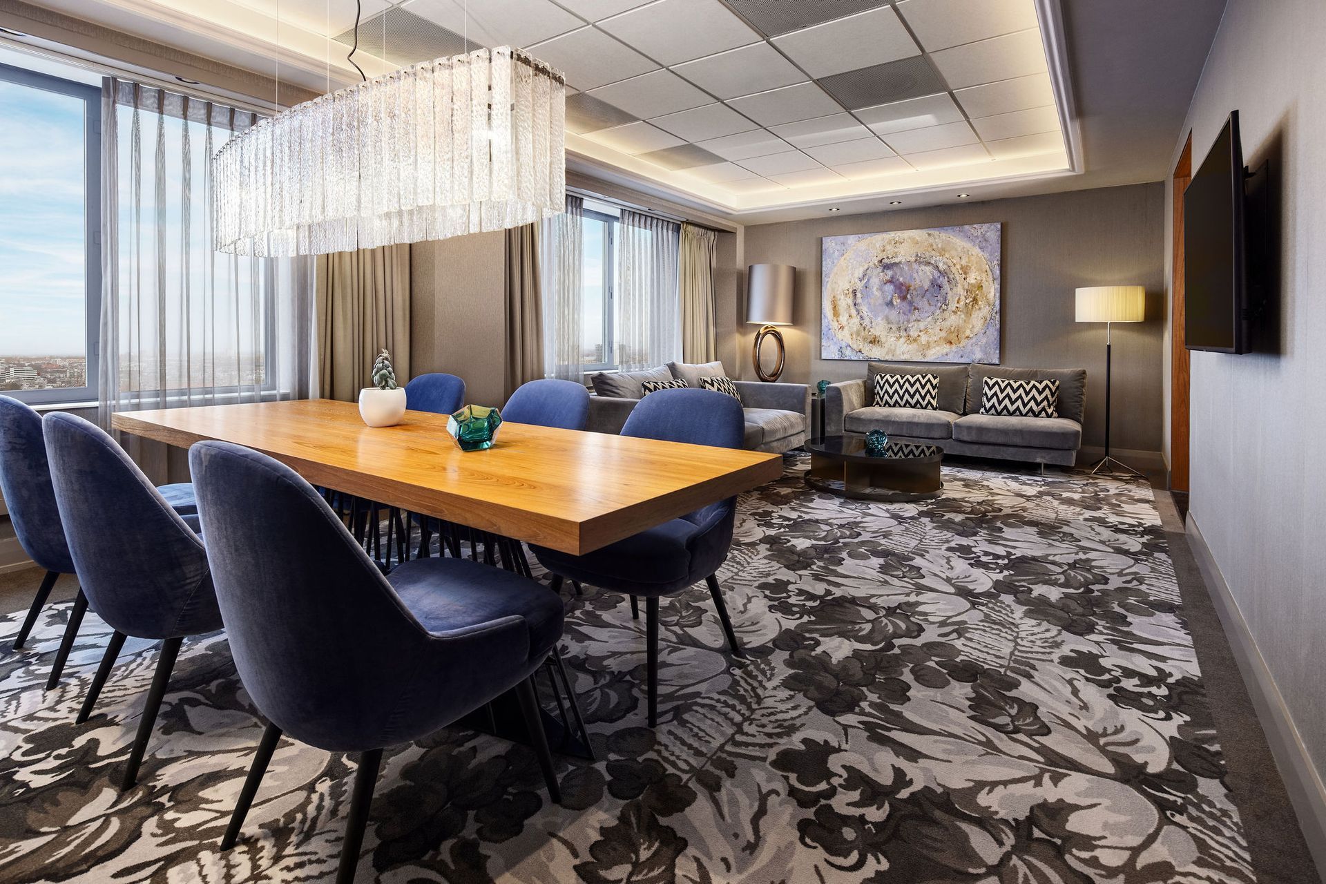 A dining room with a table and chairs in a hotel room.