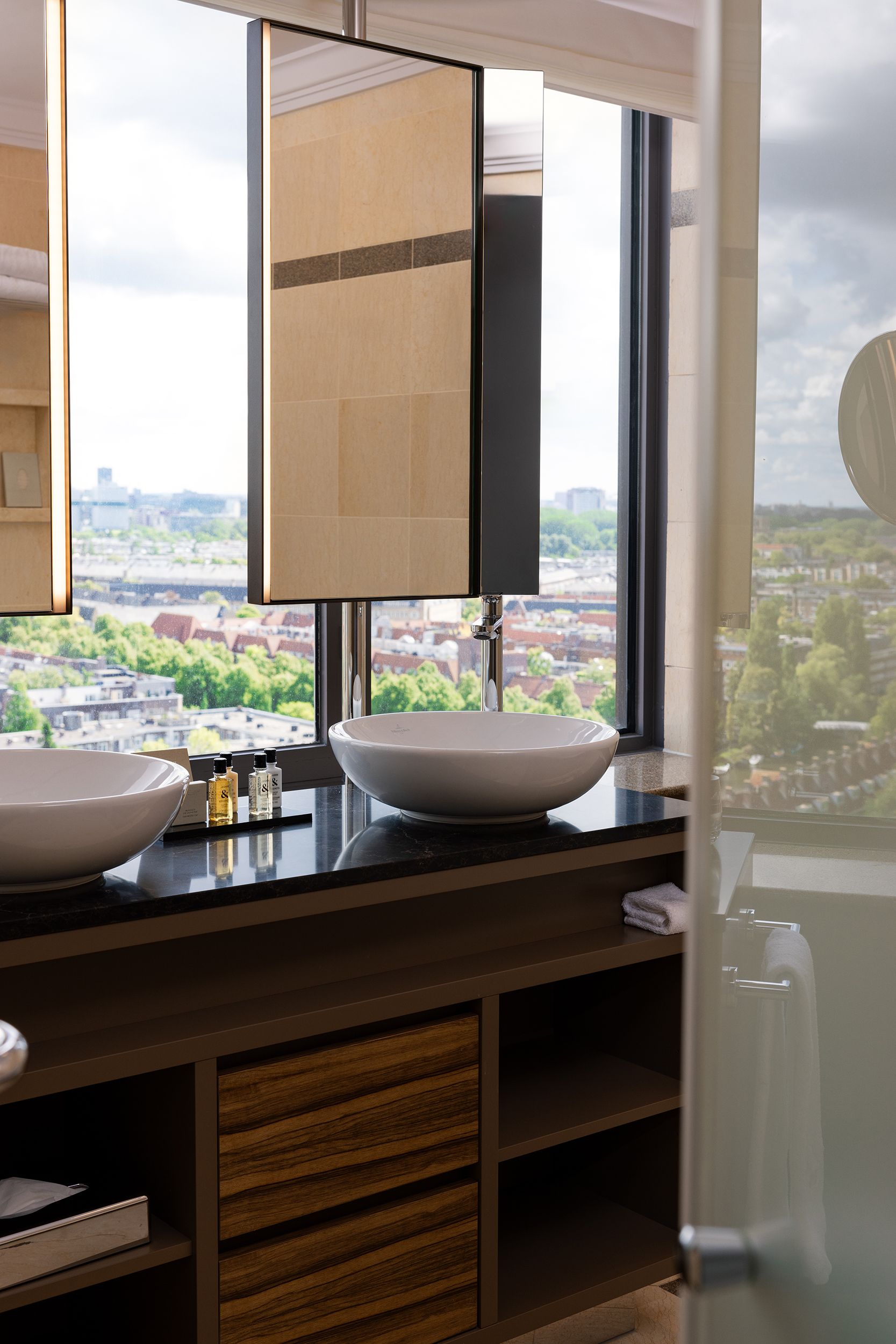 A bathroom with two sinks and a large window