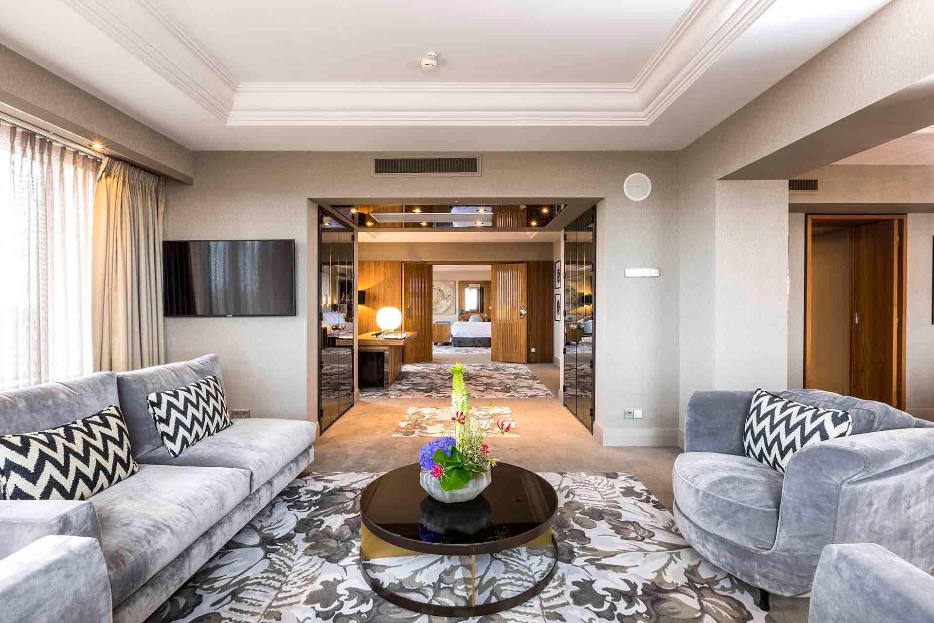 A living room with a couch , chairs , and a coffee table.