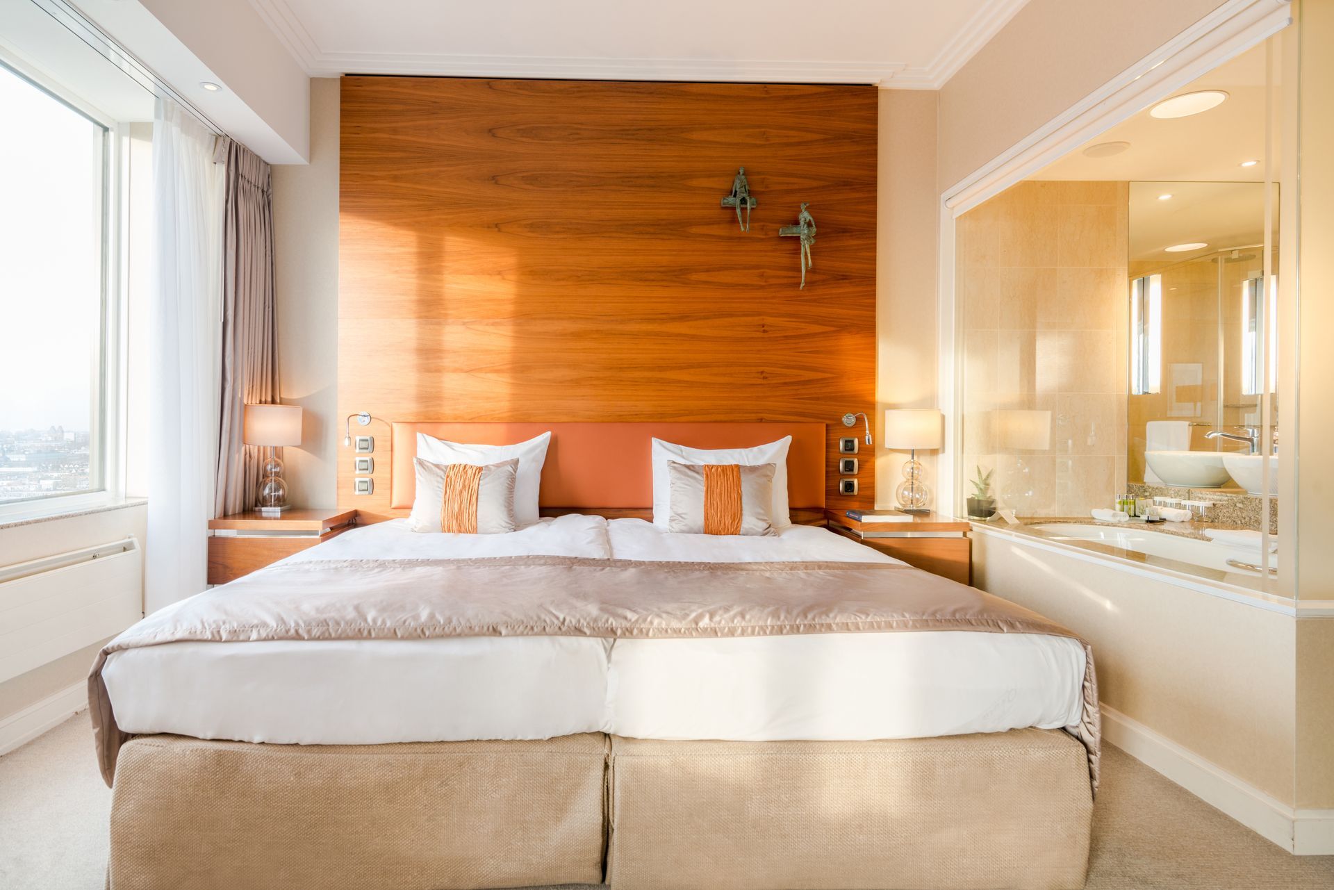 A hotel room with a king size bed and a bathroom.