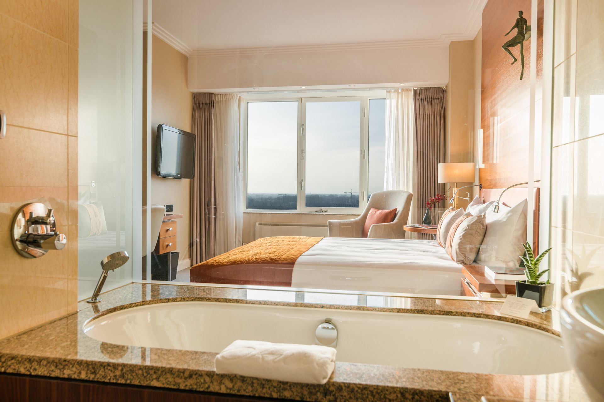 A hotel room with a jacuzzi tub and a large bed.