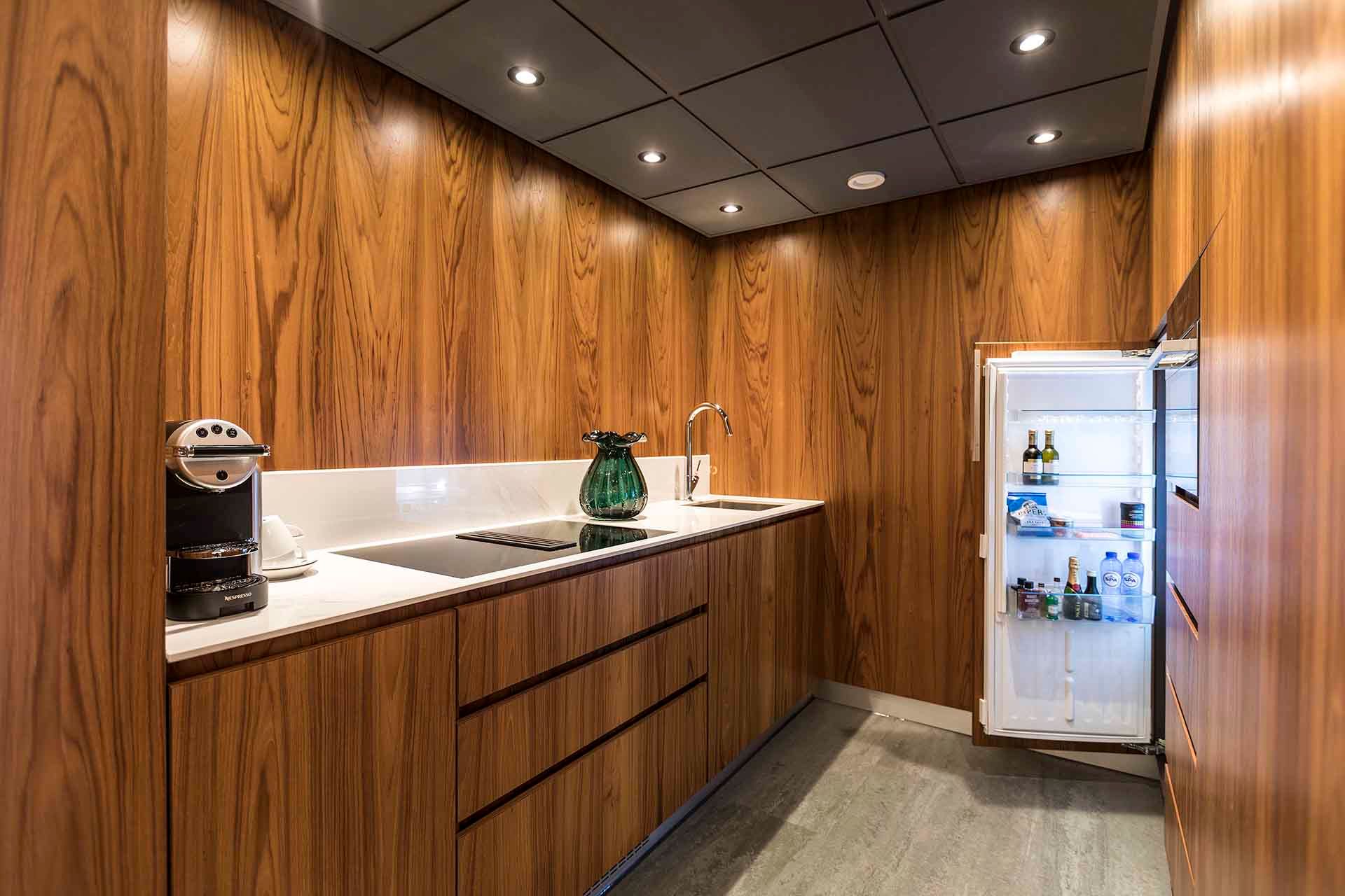 A kitchen with wooden cabinets and a refrigerator.