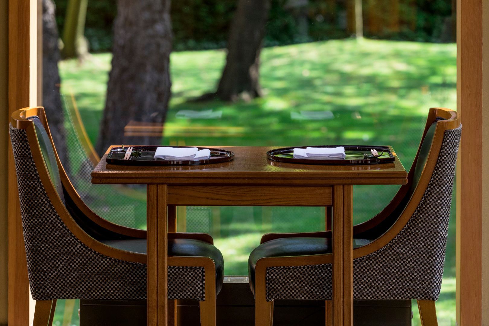A table and chairs are sitting in front of a window.