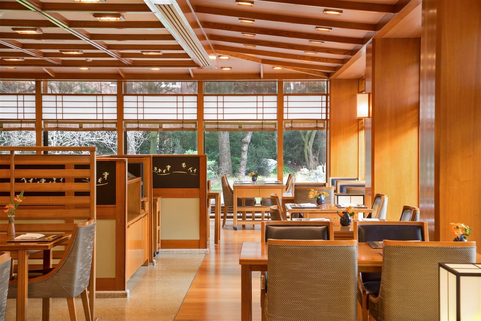 A restaurant with tables and chairs and a lot of windows
