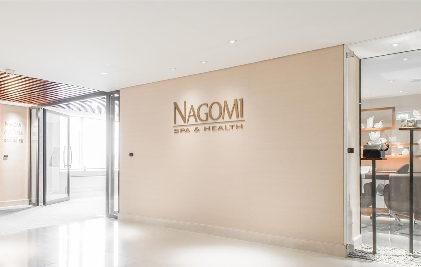 A large beige wall with the word nagomi on it.