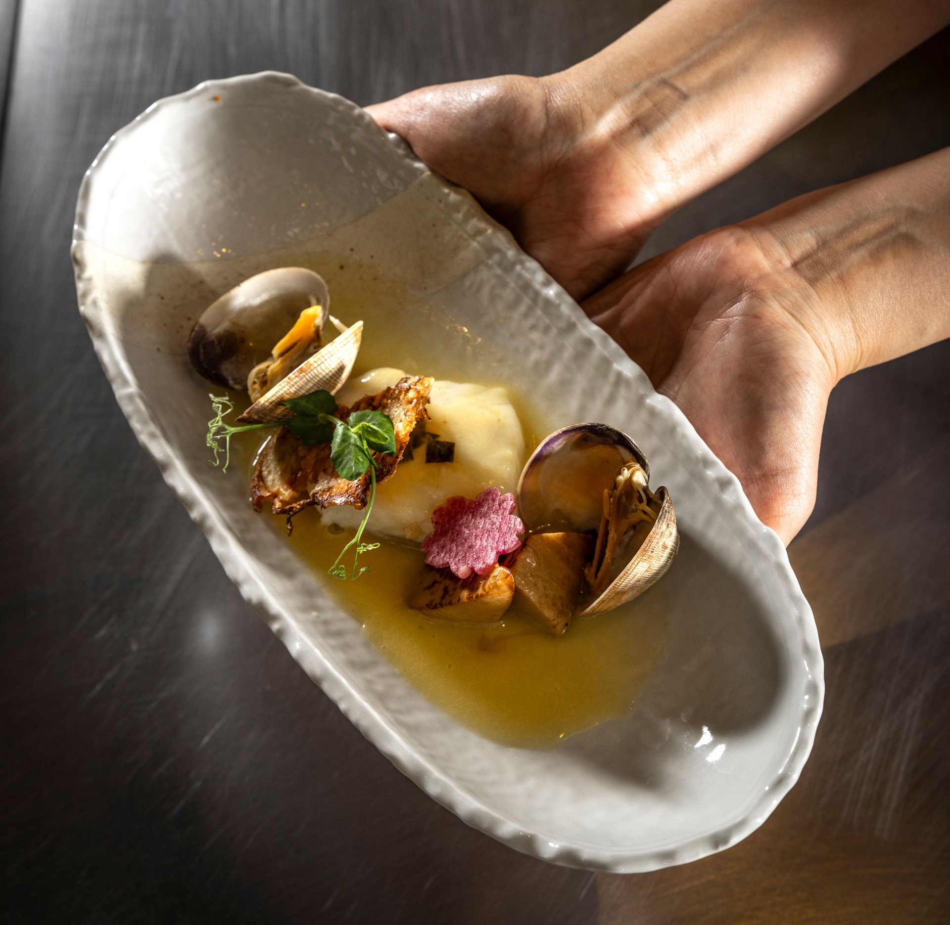 A chef is cooking food on a grill in a restaurant.