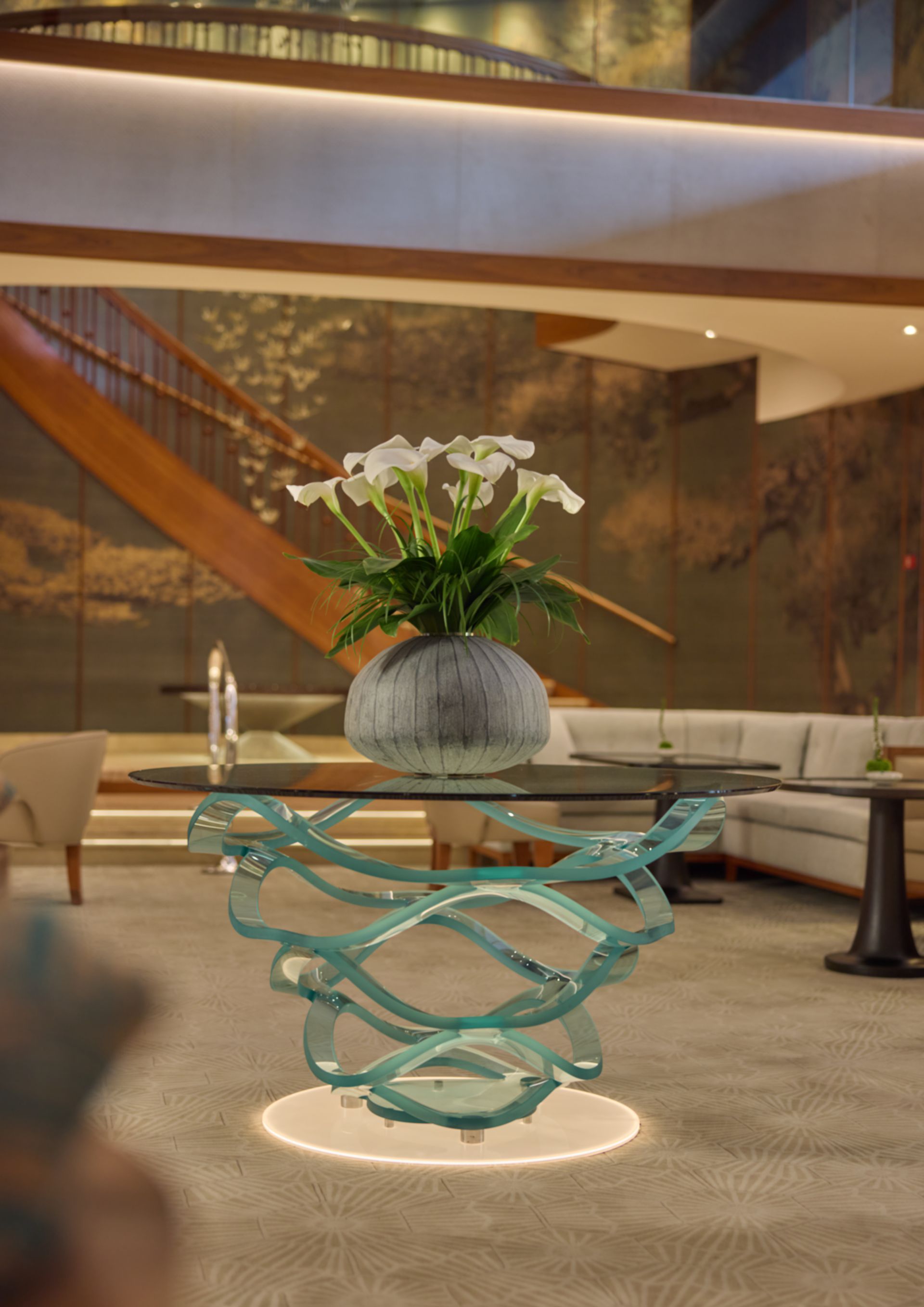 A room with a chair a table and a lamp