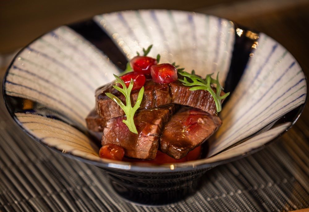 A close up of a bowl of food on a table.